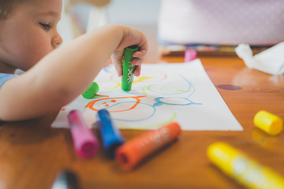 Child Playing With Colored Pencils